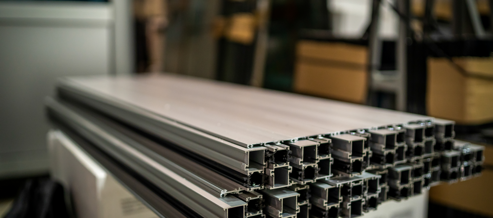 A stack of aluminum extruded sections in a warehouse.