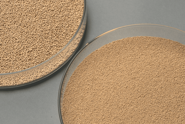 Two round plates with sand on top of them.