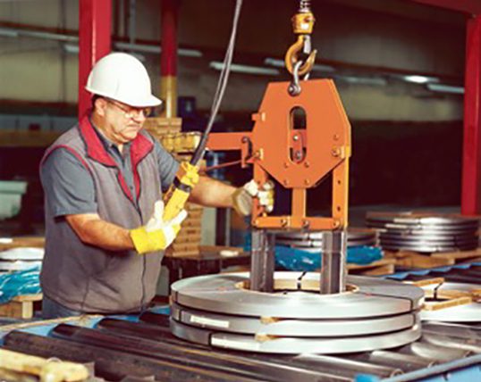 A man working in an industrial setting with a crane.